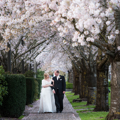 salem portland oregon wedding photography cherry blossoms bride groom walking